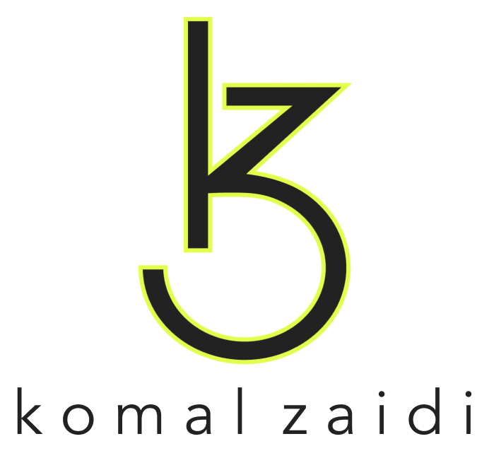 Modern minimalist monogram logo featuring a stylized lowercase “k” and curved “z” combined into a sleek black geometric symbol on a transparent background. Below the icon, the portfolio/website owner’s name “komal zaidi” appears in spaced lowercase sans-serif typography. Elegant luxury branding design with clean lines, contemporary aesthetics, and professional creative studio identity styling.